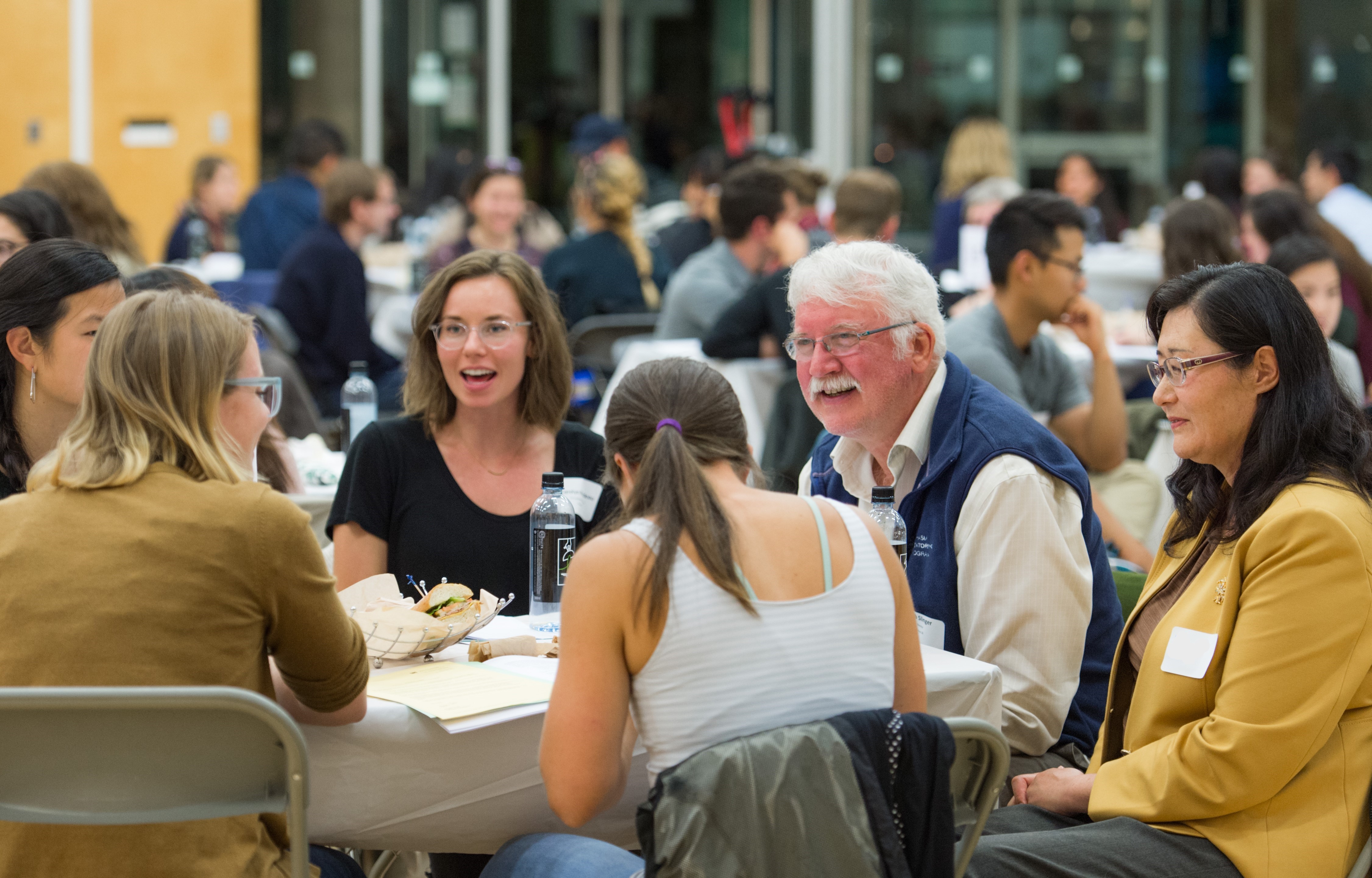 Patients and caregivers sitting at a table talking with each other