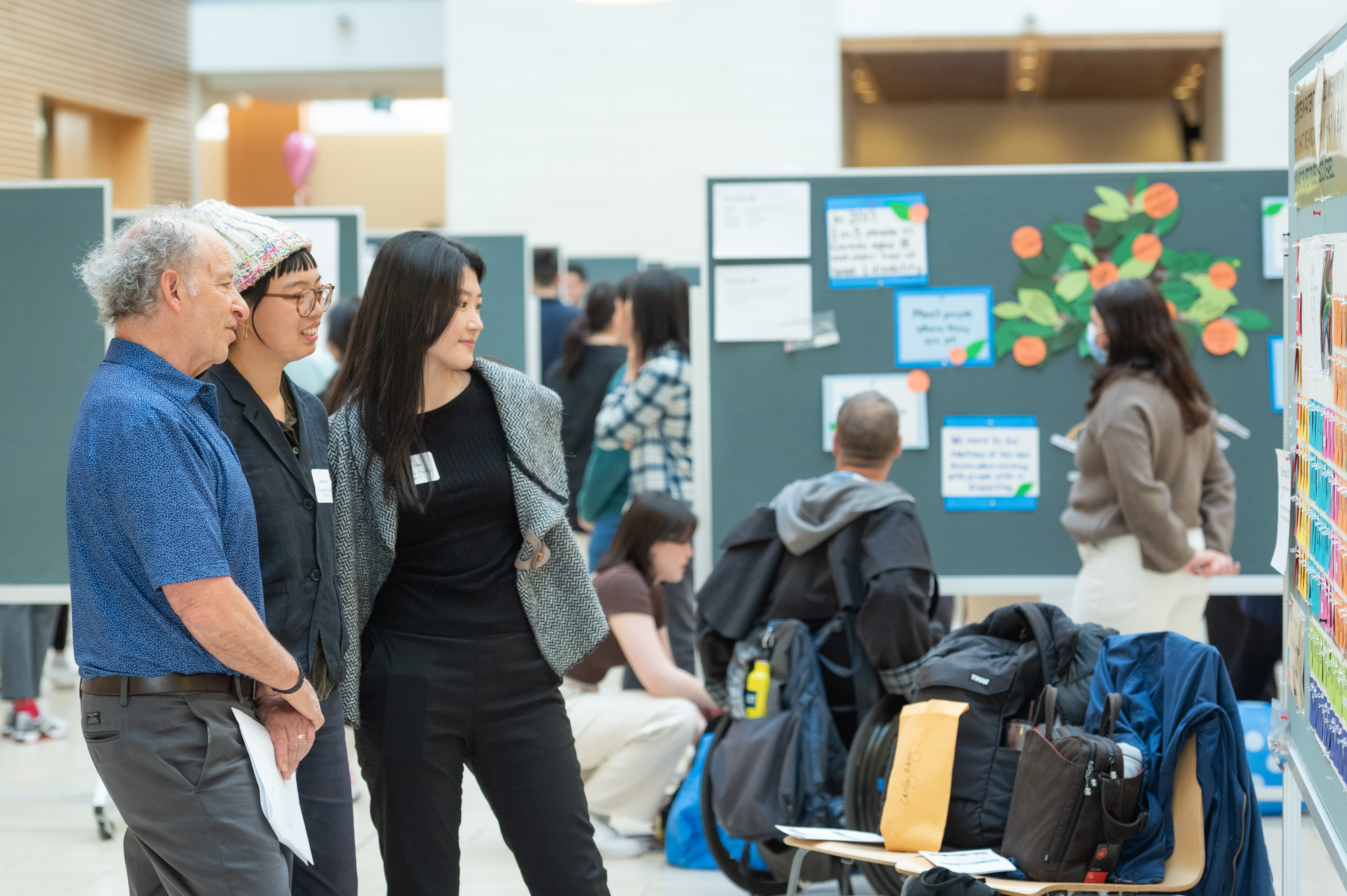 Photo of students and health mentors looking at poster presentations