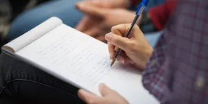 Someone taking notes in a notebook