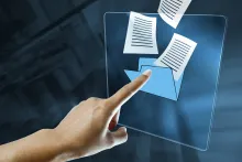 Photo of finger posting at documents coming out of a folder