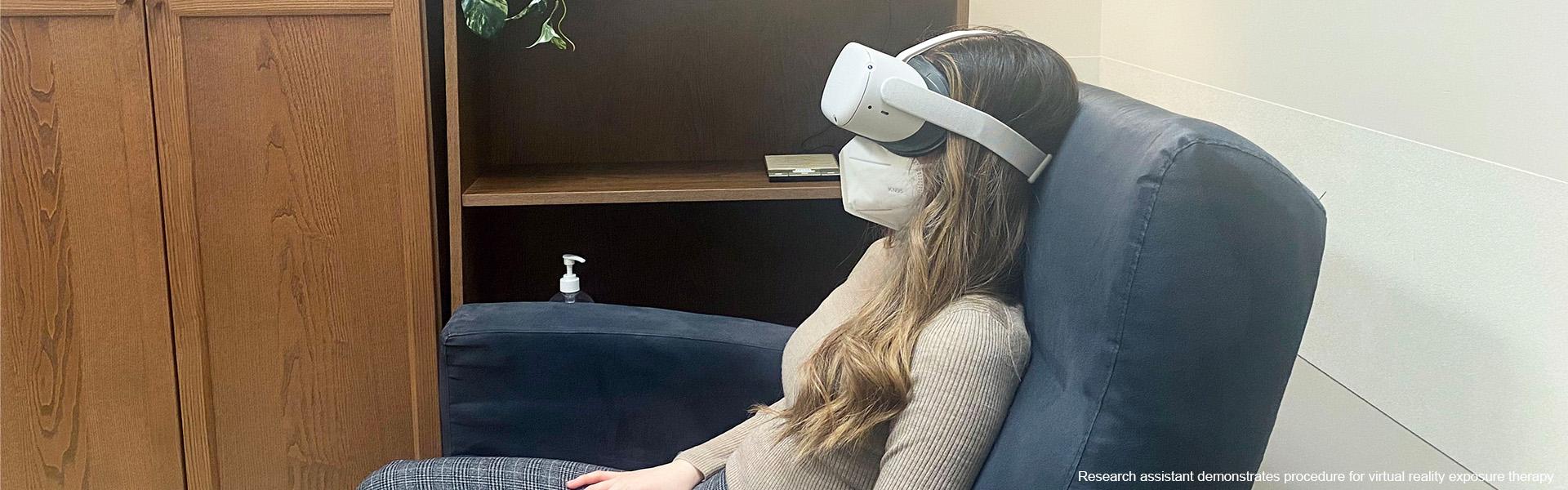 Photo of research assistant demonstrating procedure for virtual reality exposure therapy
